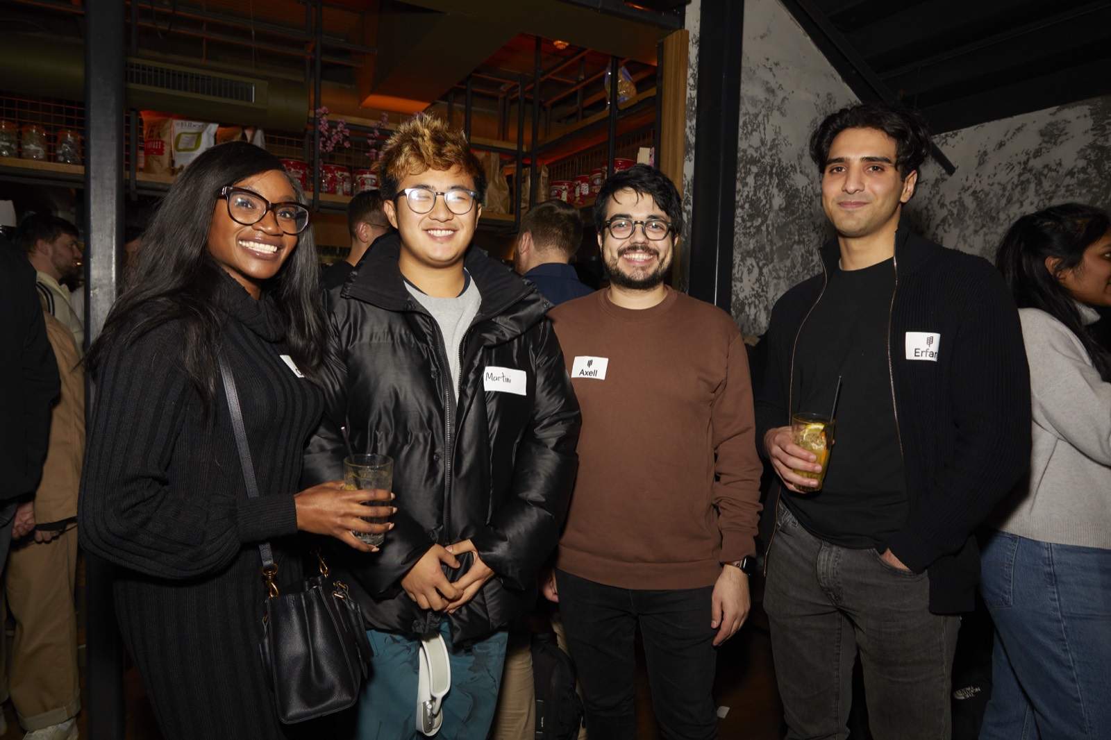 Four people with name tags at a GrowthMentor meetup