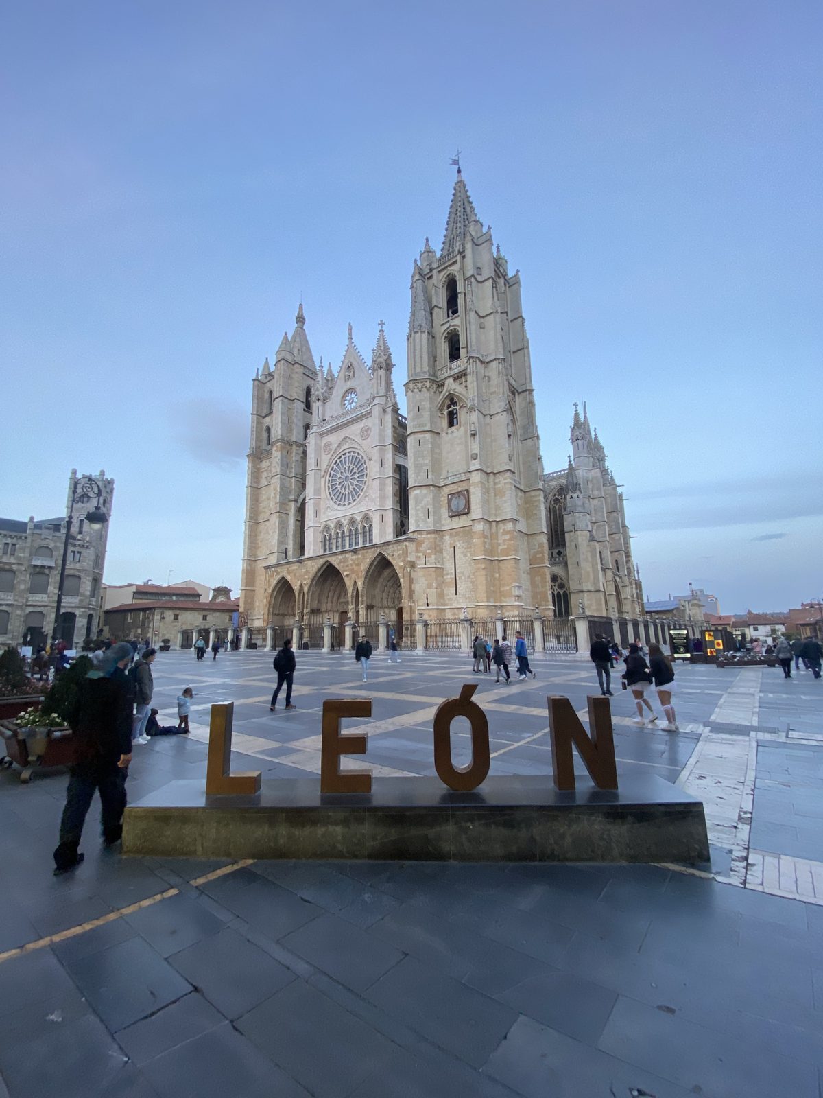 Large LEON letters in a plaza in front of the Gothic Leon cathedral at dusk