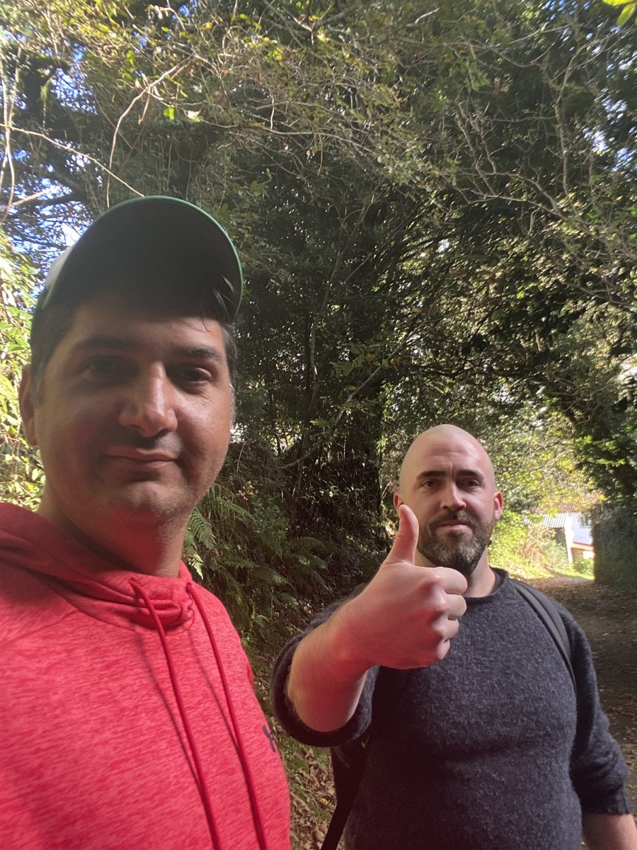 Selfie with Matthew Kay giving a thumbs up on a wooded trail near Santiago